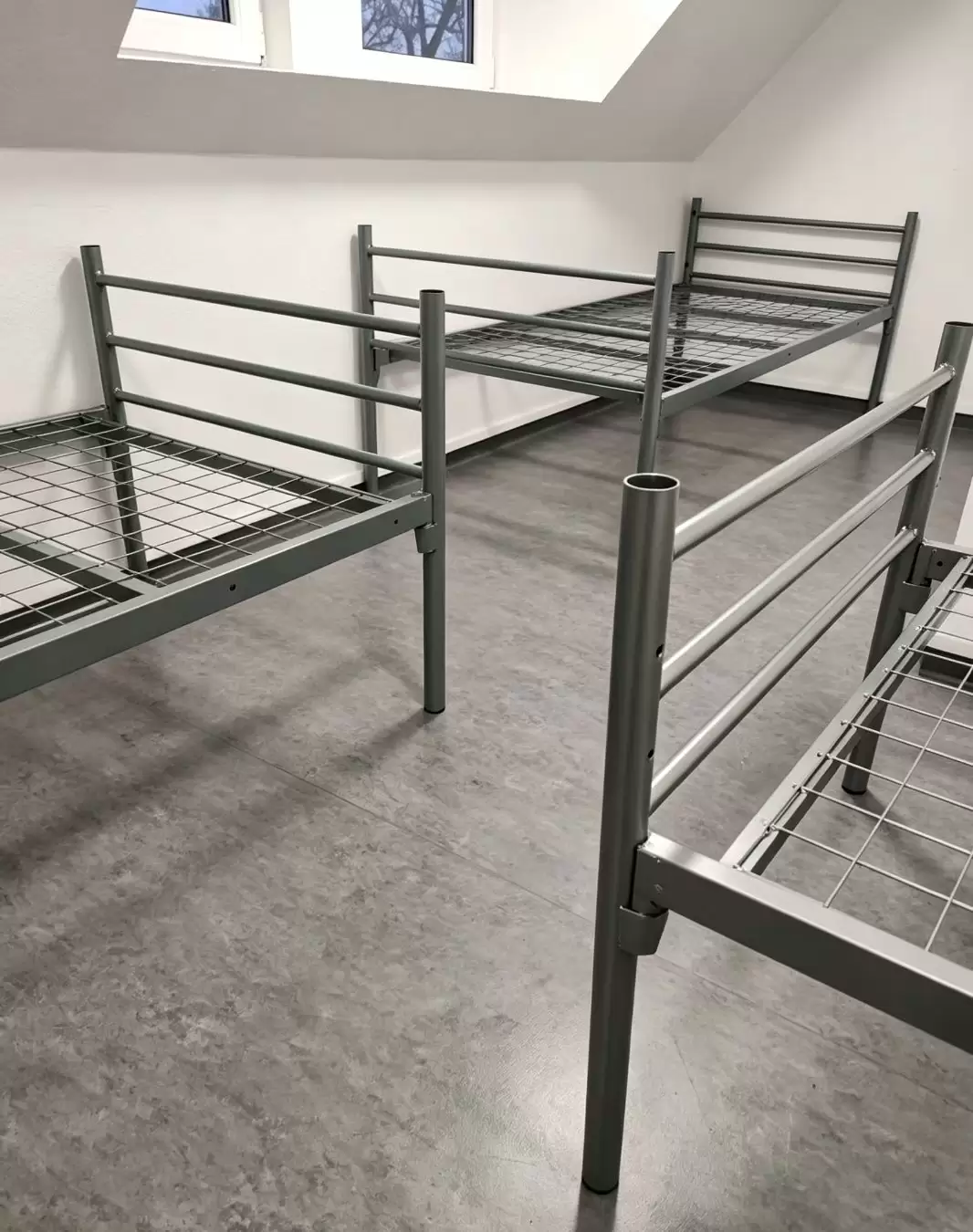Installed modular steel beds in a German refugee accommodation room